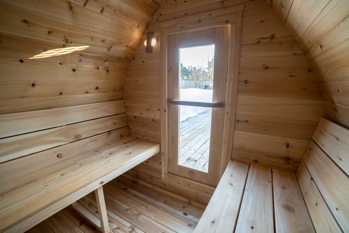 MiniPOD cedar interior with opposing benches and glass-panel door