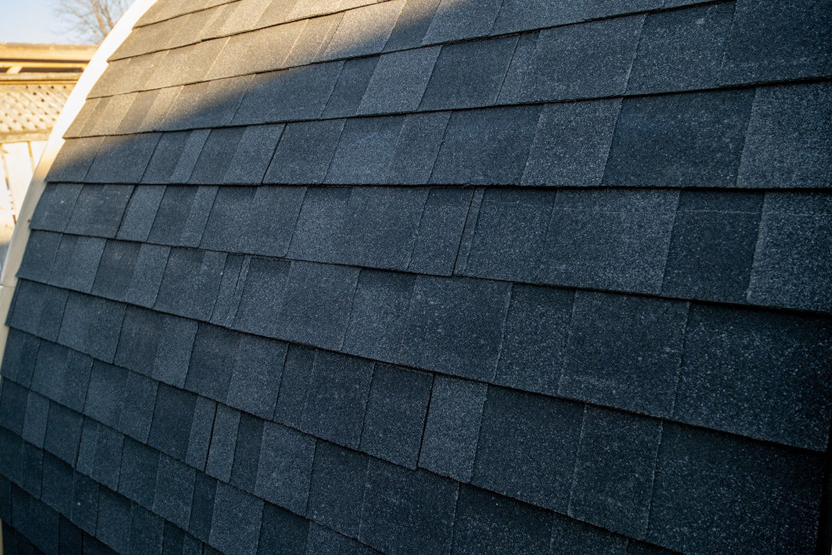 Close-up of MiniPOD black asphalt shingles and curved roof profile